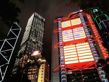 Low angle view of illuminated buildings in city at night