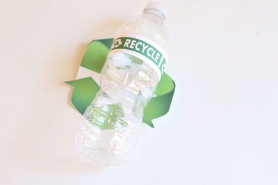 Close-up of jar bottle against white background