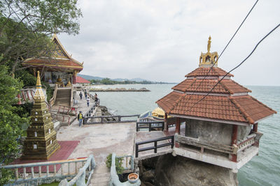 Temple by building against sky