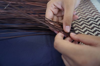 High angle view of person weaving on table