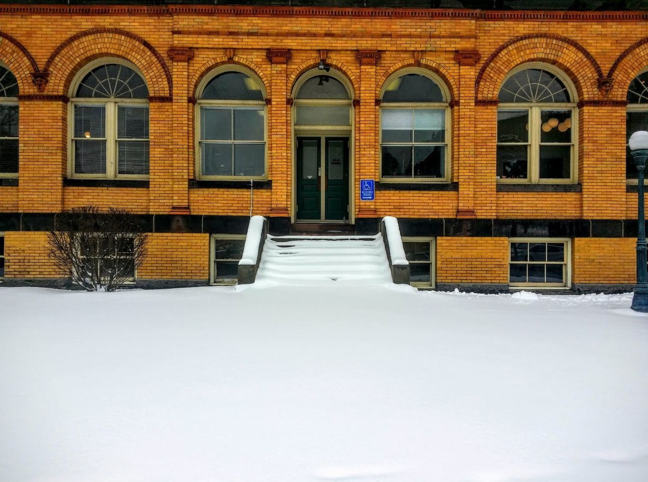 BUILDING BY SNOW COVERED HOUSES