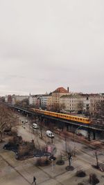 High angle view of street by buildings against sky