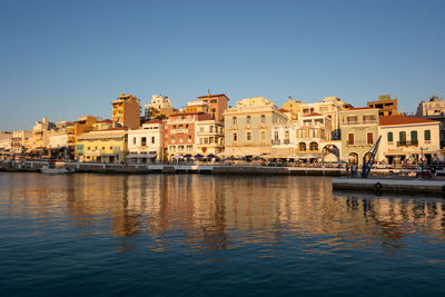 Buildings in city against clear sky