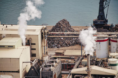 High angle view of smoke emitting from factory at recycling center at commercial dock, barcelona 