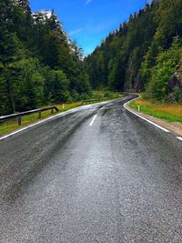 Surface level of country road against sky