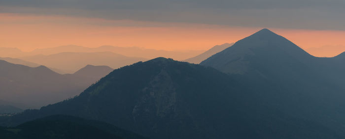 Scenic view of silhouette mountains against sky during sunset