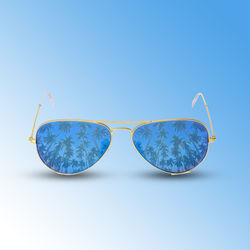 Close-up of sunglasses against blue background