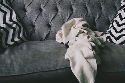 Low section of man relaxing on sofa