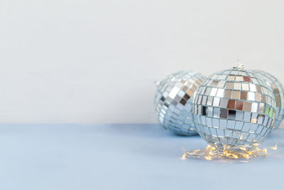 Close-up of glass container on table against white background