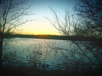 Scenic view of lake against sky at sunset