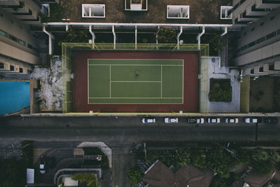 Directly above shot of tennis court amidst buildings in city