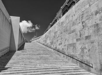 Low angle view of staircase by building against sky, valletta city gate, malta