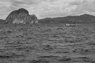 Sailboats sailing in sea against sky