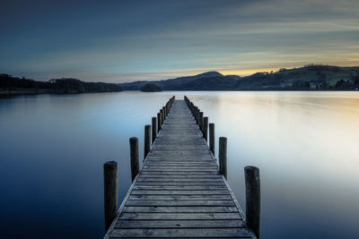 Pier over lake against sky