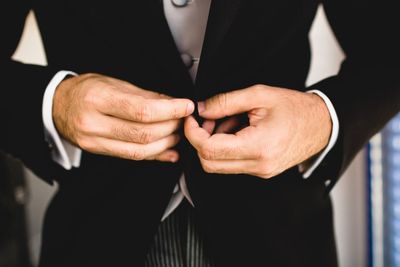 Midsection of bridegroom wearing suit