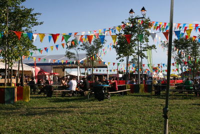 People hanging in park against sky