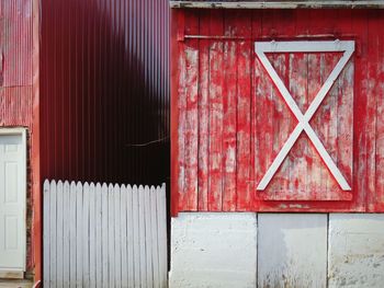 Red closed door of barn