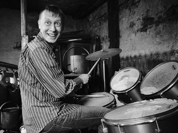 Portrait of happy man playing drum