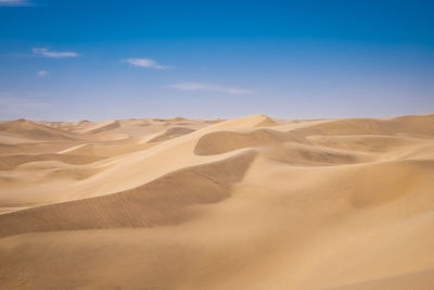 Sand dune in desert against sky