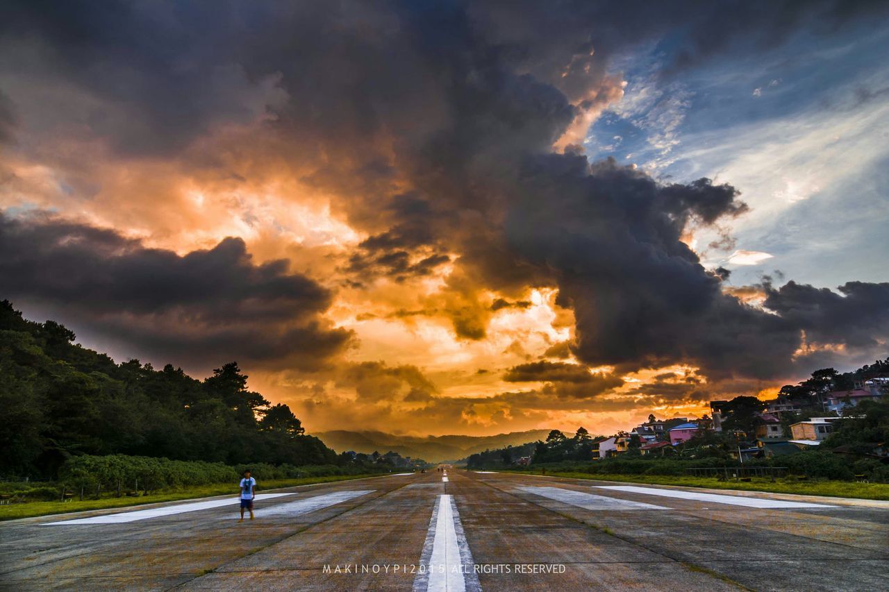 transportation, sky, cloud - sky, sunset, road, the way forward, cloudy, land vehicle, car, street, dramatic sky, cloud, weather, diminishing perspective, orange color, mode of transport, road marking, country road, storm cloud, beauty in nature
