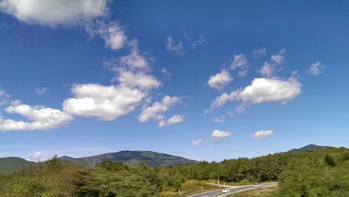 Scenic view of mountains against cloudy sky