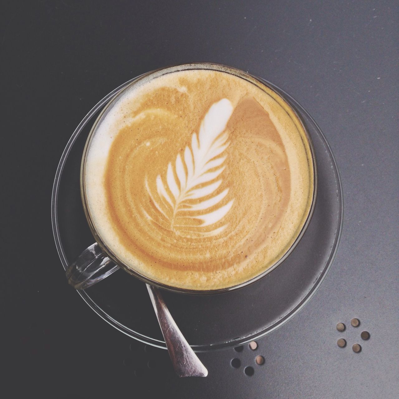 indoors, food and drink, coffee cup, table, still life, coffee - drink, froth art, cappuccino, high angle view, directly above, frothy drink, drink, saucer, freshness, refreshment, close-up, spoon, studio shot, coffee, creativity