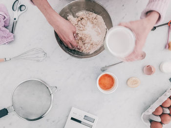 Cropped image of woman preparing scone in kitchen at home