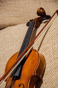 Close-up of violin on sofa