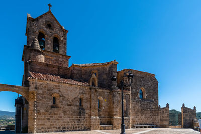 Low angle view of historic building against blue sky