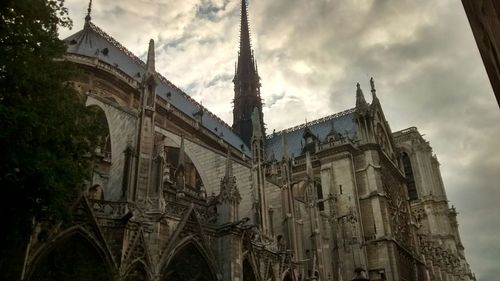 Low angle view of building against cloudy sky