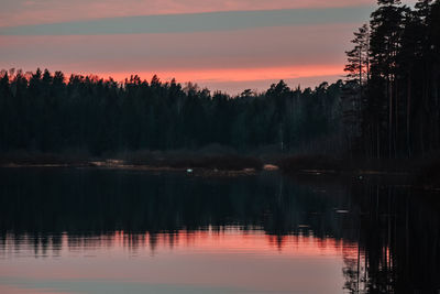 Scenic view of lake against romantic sky at sunset