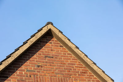 Low angle view of building against clear blue sky