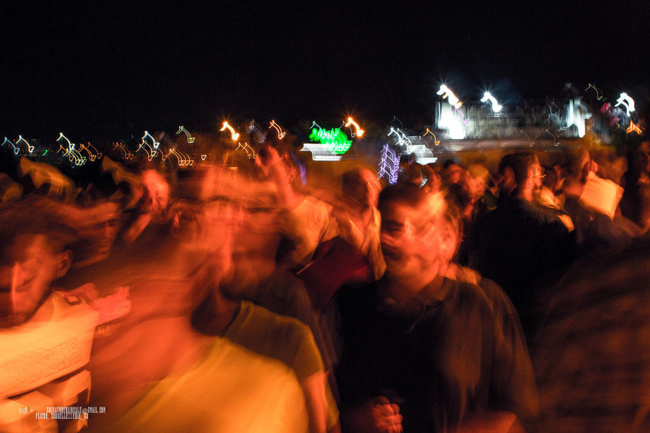 GROUP OF PEOPLE STANDING IN DARK