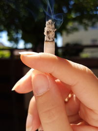 Close-up of woman hand holding a cigarette