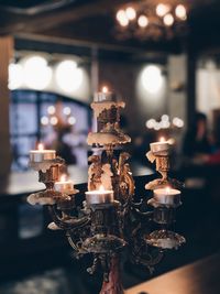 Close-up of lit tea light candles in temple