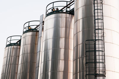 Low angle view of industry against clear sky