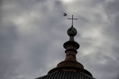 Low angle view of a building against cloudy sky