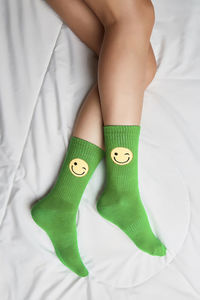 Low section of woman lying on bed