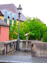 Houses by street against sky in city