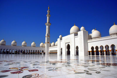 View of mosque against clear blue sky