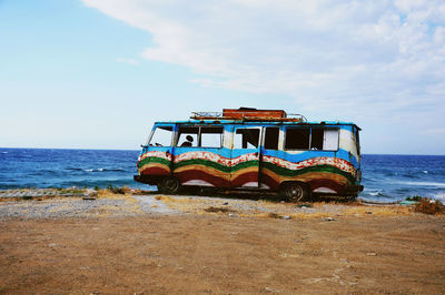 Lifeguard hut on beach against sky