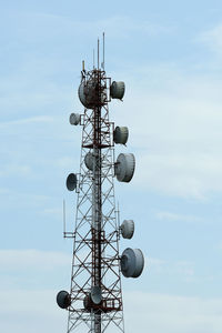 Low angle view of communications tower against sky