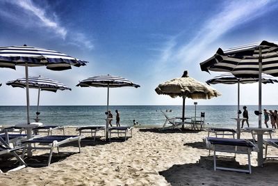 People on beach against sky