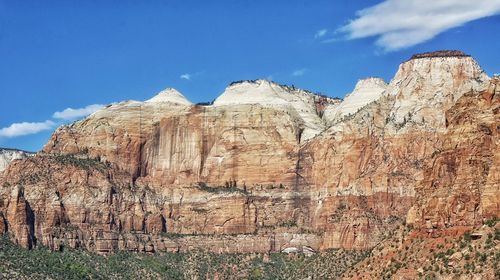 Low angle view of mountain against blue sky