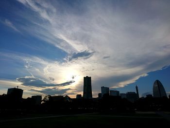 View of cityscape against cloudy sky