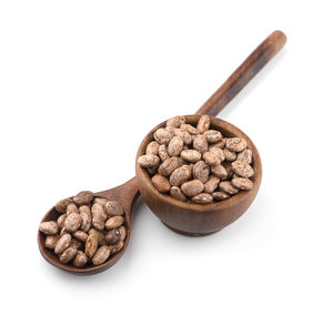 High angle view of coffee beans against white background