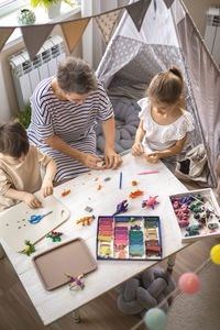 High angle view of family playing with toy blocks at office