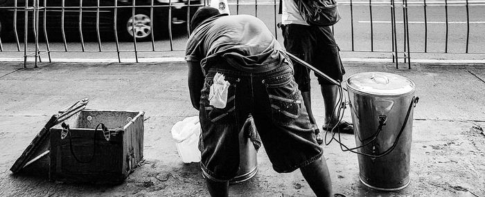 Midsection of man with umbrella