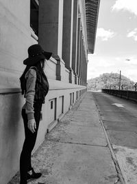 Rear view of woman walking on bridge in city