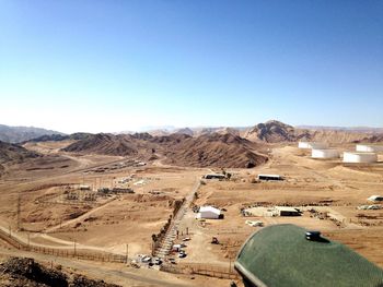 View of desert against clear blue sky